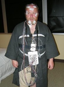 Man with monitoring wires attached for PSG sleep study