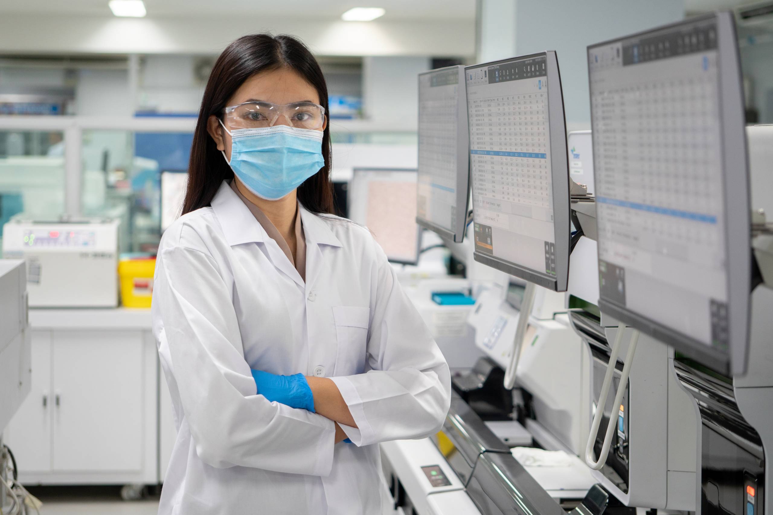 Woman scientist in lab in front of computer displays